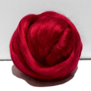 May include: A ball of bright red wool fibre, ideal for felting or spinning.