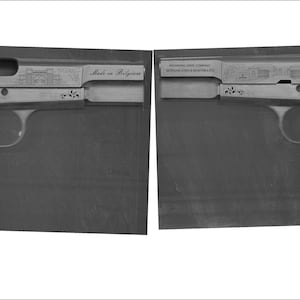 May include: Two disassembled parts of a silver handgun with intricate engravings. The top part shows the barrel and the bottom part shows the grip and trigger. The text "Made in Belgium" is engraved on the top part.