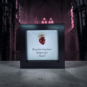 May include: A black framed artwork with a red anatomical heart and gold detailing. The white background displays the text "Every beat of my heart belongs to you Sarah!"