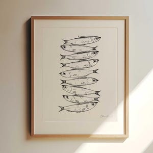 Nine whimsical sardines in a vertical line, each swimming in a different direction, line drawing print with moody, storybook, cottagecore style. Kitchen Decor Sardine print.