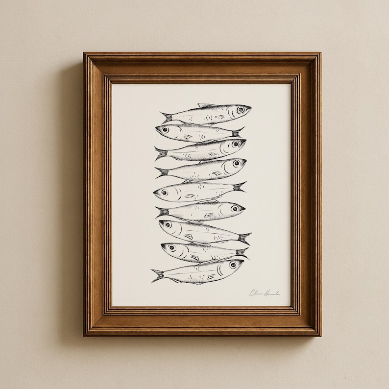 May include: A framed art print featuring a stack of stylized fish illustrations in black ink on a cream background. The artwork is enclosed in a brown wooden frame, creating a classic and elegant aesthetic. The fish are detailed with visible scales and fins.