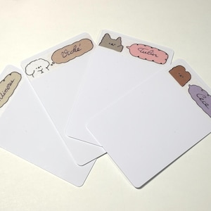 May include: Four white rectangular cards with rounded corners. Each card has a different cartoon animal and name in a speech bubble. The animals are a yellow bear, a white dog, a gray cat, and a brown bear. The names are "Minoru", "Viché", "Tulin", and "Cece".