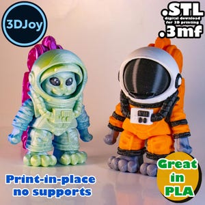 May include: Two 3D printed astronaut figurines, one green and one orange, with the text "STL digital download for 3D printing .3mf" and "Print-in-place no supports Great in PLA" on the image.