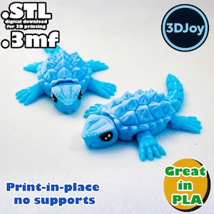 May include: Two light blue 3D-printed turtle figurines. The turtles have detailed shells and limbs. The image includes text that says "STL digital download for 3D printing .3mf" and "Print-in-place no supports" and "Great in PLA".