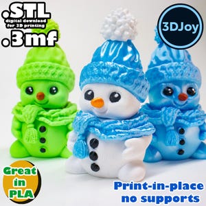 May include: Three 3D printed snowman figurines, one green, one blue, and one white with a blue hat and scarf. The white snowman has a carrot nose and black eyes. The text "3DJoy" and "Print-in-place no supports" is visible in the image.