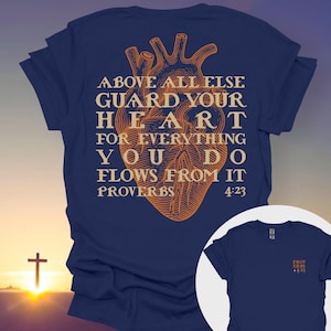 Christian T-Shirt with Proverbs 4:23 | Bold Anatomical Heart Design | Spiritual Bible Verse Apparel in Orange Amber on Black
