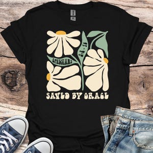 Retro Christian T-Shirt with Floral Design, Saved by Grace Graphic, Ephesians 2:8-10 Bible Verse Shirt, Faith-Based Groovy 70s Style