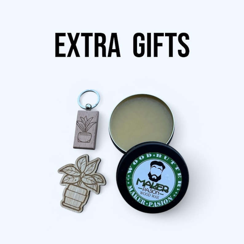 May include: Image featuring a collection of gifts. Includes a wooden keychain and a wooden plant-shaped cutout. Also shown are two containers of wood wax, one open and one closed, with the text "EXTRA GIFTS" at the top.