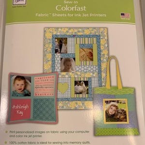 May include: A package of Colorfast fabric sheets for ink jet printers. The package shows examples of fabric projects, including a quilt, a tote bag, and a photo pillow. The projects feature photos and decorative patterns. The text "Ashleigh Kay" is visible.