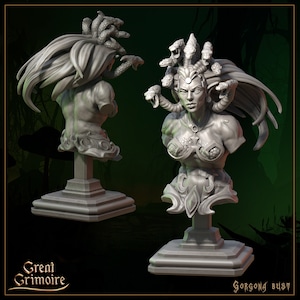 May include: A gray, detailed bust sculpture of a Gorgon with snakes for hair. The sculpture is on a square base and has a detailed design. The text "GORGONA BUST" is visible at the bottom of the image.