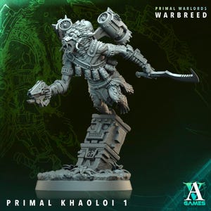 May include: A gray miniature figure of a creature with a wolf-like head, holding a hammer and a futuristic gun. The figure is on a stone base with the text "PRIMAL KHAOLOI 1" and "PRIMAL WARLORDS WARBREED". The A Games logo is in the bottom right corner.