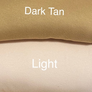 May include: A close-up of four fabric swatches in shades of brown and tan. The colors are labeled "Dark", "Dark Tan", "Light", and "Tan" in white text. The fabric appears to be a smooth, woven material.