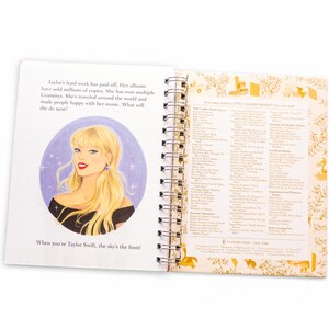 May include: Open book with a spiral binding featuring an illustration of a blonde woman in a black top. Text on the left page reads "When you're Taylor Swift, the sky's the limit!" The right page lists titles.