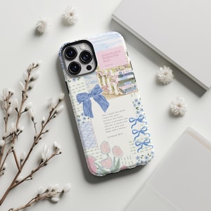 May include: A phone case with a patchwork design featuring a blue bow, floral patterns, and the text "GOD'S PLAN IS WORTH THE WAIT." The case has a light blue and white color scheme with a picture of a white picket fence and flowers.