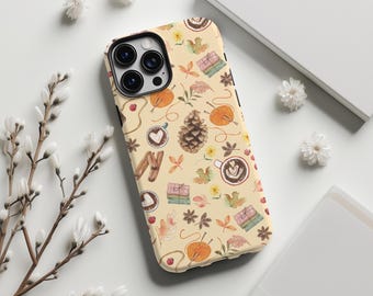 May include: A phone case with a fall-themed pattern. The design includes pumpkins, coffee cups, yarn, leaves, and a pinecone on a cream-colored background. The case has a black border and a camera cutout.