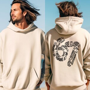 May include: A beige hoodie with a front pocket and a hood. The back of the hoodie features a black graphic with the text "Ezekiel 6:7" surrounded by other biblical verses. The hoodie is worn by a person.