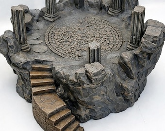 May include: A detailed miniature diorama of a stone platform with four classical columns. The platform has a central circular design and a set of stairs leading up to it. The color palette is primarily gray and brown.