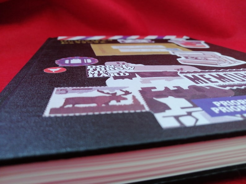 May include: A black hardcover journal with a variety of colorful stickers and text, including "Don't Throw Me Hard" and "Prior Prior Prior".