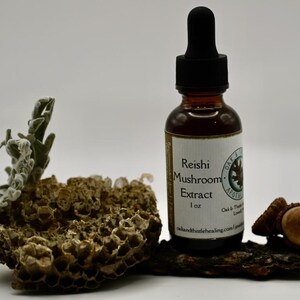 May include: A brown glass bottle of Reishi Mushroom Extract with a black dropper, set on a piece of wood with decorative elements. The label reads "Reishi Mushroom Extract 1 oz".