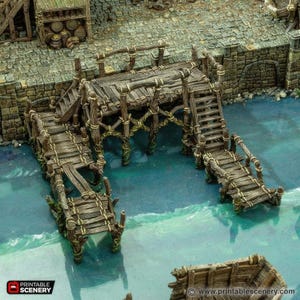 May include: A detailed miniature wooden pier with stairs and walkways, designed for tabletop gaming. The pier is weathered with a rustic appearance, featuring visible wood grain and rope detailing. The structure is set over a blue water surface, with a stone wall and building in the background.