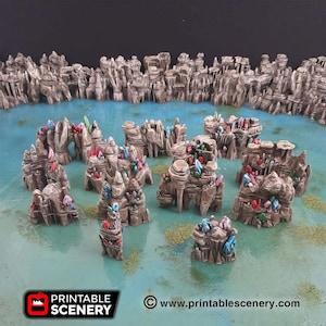 May include: A tabletop fantasy terrain set featuring miniature rock formations with colorful crystal accents. The scene includes a blue water effect and small patches of green vegetation. The Printable Scenery logo is visible in the lower left corner.