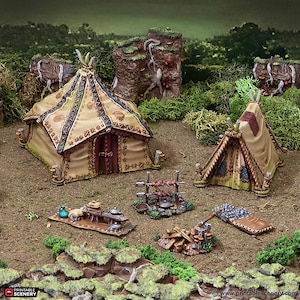 May include: A miniature tabletop gaming set featuring two tents, a cooking fire, a table with a stool, and a pile of firewood. The tents are made of beige fabric with brown trim and intricate patterns. The set is perfect for creating a medieval or fantasy village scene.