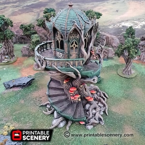 May include: A detailed miniature fantasy treehouse with a spiral staircase, balcony, and domed roof. The structure is primarily green and brown, with red mushroom accents. The base of the treehouse features the text "PRINTABLE SCENERY" and the website address.