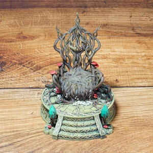 May include: A detailed fantasy throne sculpture with a tree-like back and mushroom accents. The throne is set on a round base with steps, featuring green and gold details. The sculpture is made of a brown and green material.