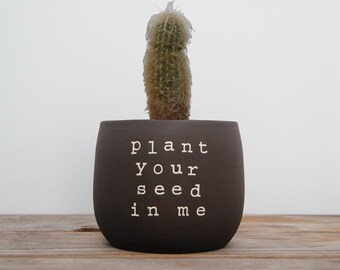 Plant your seed in me. Black pot with dirty humor.