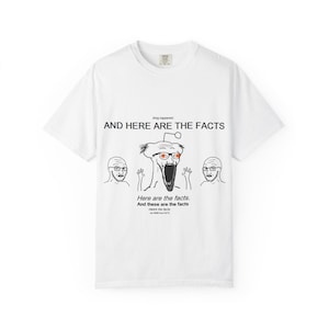 May include: White t-shirt featuring a meme-style graphic with the text "AND HERE ARE THE FACTS." The design includes a central caricature with glasses and an open mouth, flanked by two smaller figures. Below, the text repeats "Here are the facts."