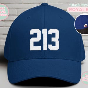 May include: Royal blue Flexfit 6277 baseball cap with the number "213" in white block letters. The cap has a curved brim and a structured fit. The text "MORE COLOR OPTIONS" and "HIGH-QUALITY EMBROIDERY" are also visible.