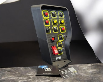 May include: A black Race Series control panel with multiple buttons in yellow and red. The panel has a carbon fiber texture and includes a red toggle switch and a business card with the Race Series logo.