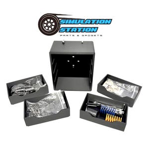 May include: A black storage unit with the text "SIMULATION STATION PARTS & GADGETS" above it. The unit has several small black trays containing tools and parts. Some items are in clear plastic bags.