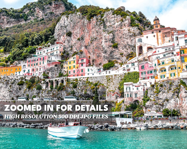 May include: A colorful village built into a cliffside overlooking a turquoise body of water. A white boat with a wooden deck is in the foreground. The text "Zoomed in for details" and "High resolution 300 DPI JPG files" is at the bottom of the image.