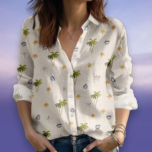 May include: White button-down shirt with a tropical pattern. The shirt features a repeating design of green palm trees, yellow flowers, and white seashell shapes. The long-sleeved shirt has a classic collar and buttoned cuffs.