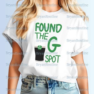 May include: White t-shirt with rolled-up sleeves featuring the text "FOUND THE G SPOT" in green. A graphic of a pint of stout with a shamrock is also printed on the shirt.