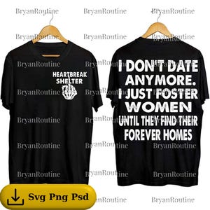 May include: Black t-shirts with white text and graphics. One shirt reads "HEARTBREAK SHELTER" with a hand gesture graphic. The other shirt says "I DON'T DATE ANYMORE. JUST FOSTER WOMEN UNTIL THEY FIND THEIR FOREVER HOMES."