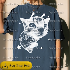 May include: Navy blue t-shirt featuring a white graphic of a cat with antennae and stars. The text "Svg Png Psd" is at the bottom. The shirt has short sleeves and a relaxed fit. The brand name "BryanRoutine" is printed multiple times.