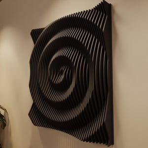 May include: A black, three-dimensional wall art piece with a spiral design. The artwork is made of layered, curved wooden slats, creating a wave-like pattern. The piece is mounted on a neutral-colored wall, showcasing a modern, abstract aesthetic.