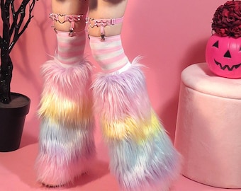 May include: Fuzzy, rainbow-colored leg warmers in shades of pink, yellow, and blue. The leg warmers are paired with striped socks and pink garter straps. A pink background and a decorative pumpkin are also visible.