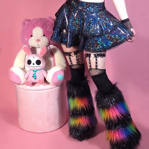 May include: A black iridescent mini skirt with a ruffled hem and black lace trim. The skirt is paired with black fishnet stockings and rainbow faux fur leg warmers.