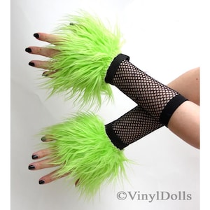 May include: A pair of lime green fuzzy wrist cuffs with black fishnet sleeves. The cuffs are made of faux fur and are attached to the sleeves with a black elastic band.