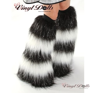 May include: Black and white striped faux fur leg warmers with a sparkly finish. The leg warmers are made of soft, fluffy material and have a stretchy elastic band at the top.