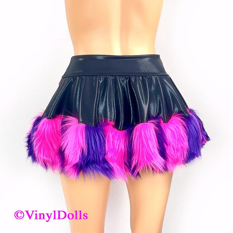 May include: A black mini skirt with a pink and purple faux fur trim. The skirt is made of a shiny, satin-like fabric.