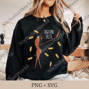 May include: Black sweatshirt with a whimsical illustration of a figure holding pasta forks, surrounded by rigatoni pasta shapes. The text "RIGATONI PASTA" is above the figure. The design is in shades of brown and yellow.