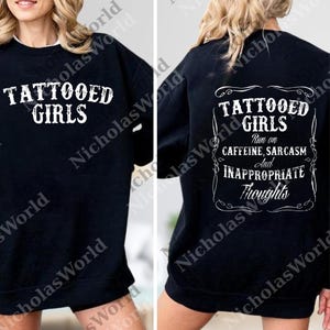 A black sweatshirt with white text and graphics on the back.