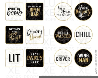 May include: A set of 12 black and gold party photo booth props with phrases like "Photo Bomb", "You Had Me At Open Bar", "Turn Down For What?", "Where The Party At...", "Party Rock Is In The House Tonight", "Dancing Queen", "Hella Wasted", "Chill", "Lit", "Best Party Ever", "Designated Driver", and "Wing Man".