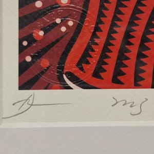 May include: A framed print of a colorful abstract art piece with red, black, and white geometric shapes. The print is signed "ms" in the bottom right corner.
