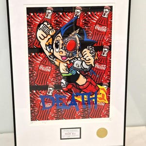 May include: A framed print of a cartoon character with a robotic body, holding a can of Coca-Cola. The character is surrounded by Coca-Cola cans and the word "DEATH" is written in blue paint across the bottom of the print.