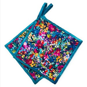 May include: Two teal blue pot holders with a colorful floral print. The pot holders are made of fabric and have a quilted design.